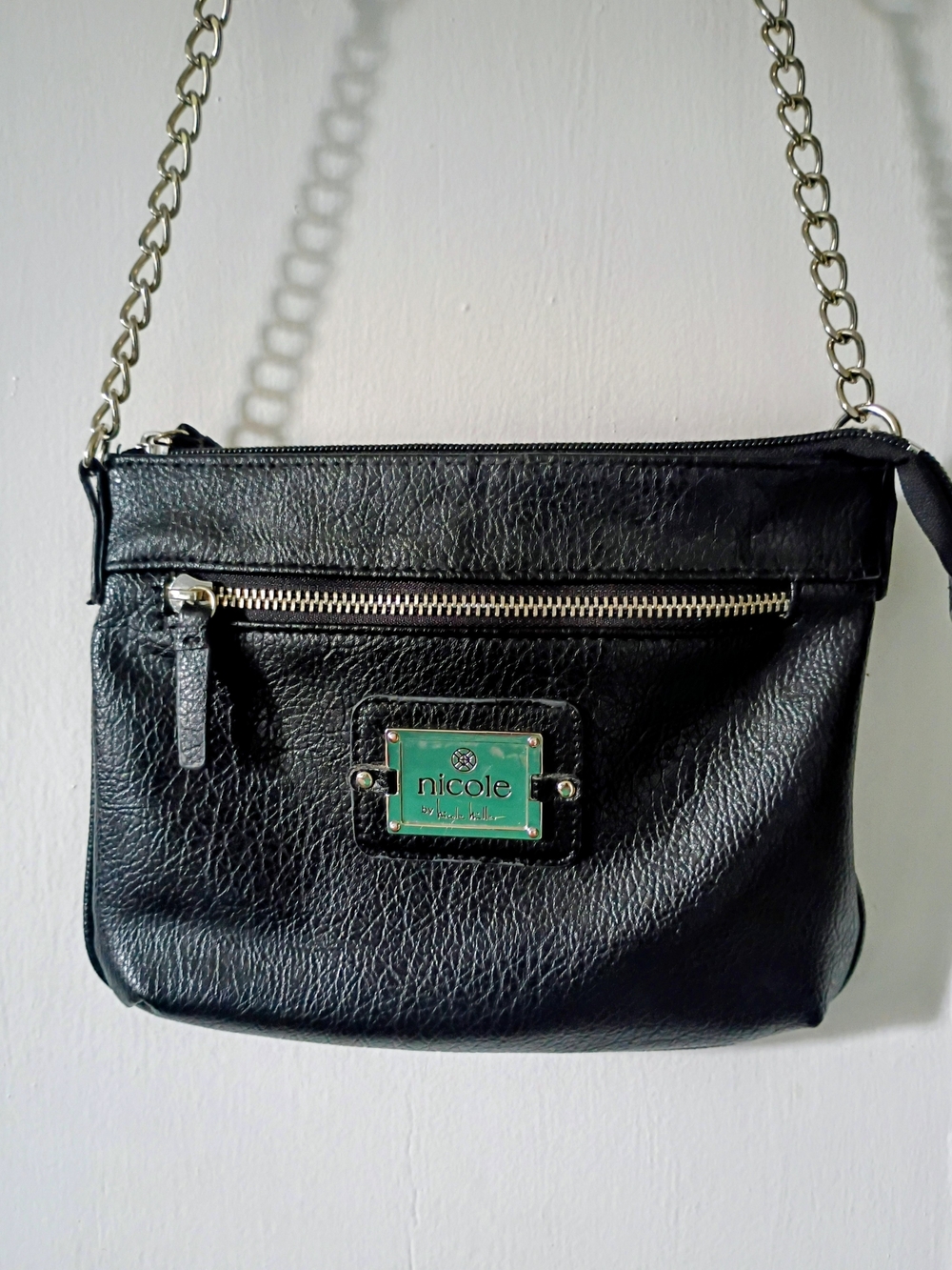 Nicole Miller Black Faux Leather Crossbody with Green Logo Plate